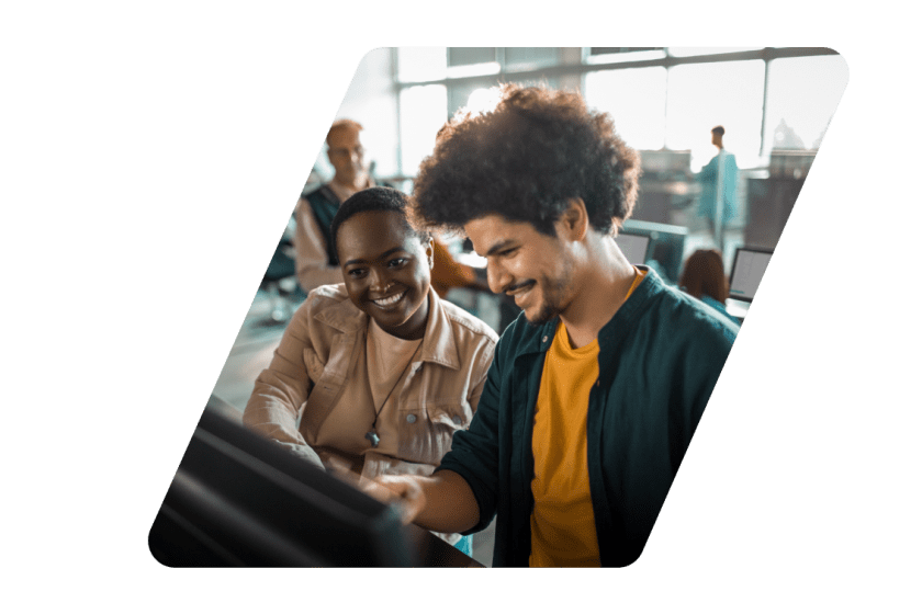 Two people smiling at a computer